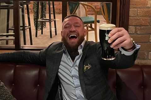 Smiling Conor McGregor enjoys pint in his Black Forge Inn pub just hours after petrol bomb attack..