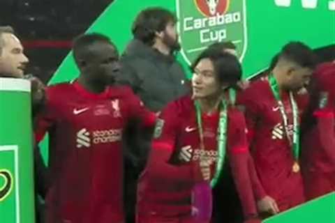 Watch Sadio Mane ask Takumi Minamino to put champagne down as Liverpool celebrate epic Carabao Cup..