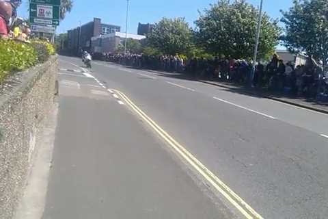 Heartstopping moment football rolls down hill as Isle of Man TT riders zoom past in narrow miss..