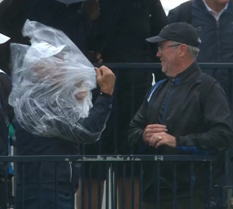Hilarious moment as spectator at The Open gets trapped inside his own PONCHO during strong winds at St Andrews