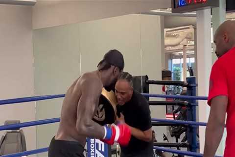 Watch Deontay Wilder’s coach take punch flush on chin from fearsome boxer but stay on his feet in..